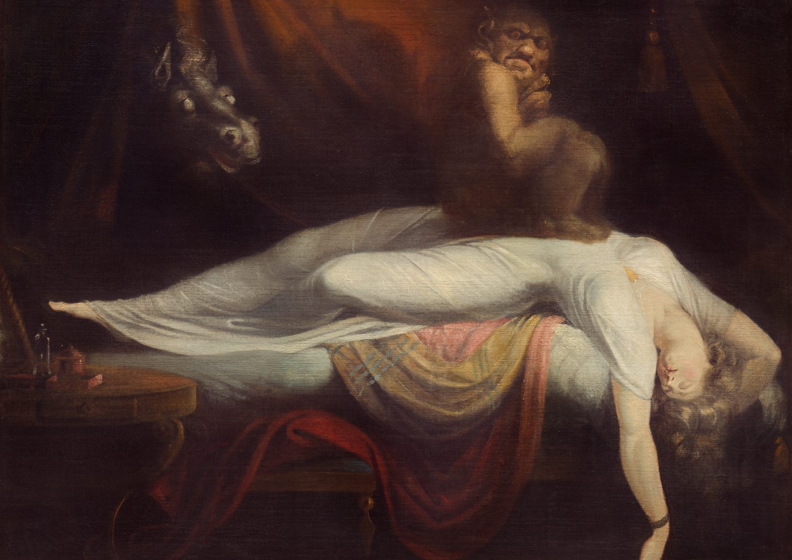 The Nightmare by Henry Fuseli, 1781. A sleeping woman in a white gown lies across a bed with her head hanging down, while a small demon sits on her chest and a horse with blank white eyes looks through crimson curtains.
