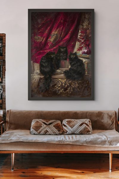 Three Black Cats by Carl Kahler as a framed print in a living room